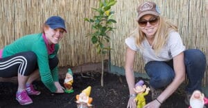 Two GPY&R volunteers planting trees at an Aruma disability service