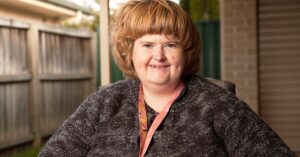 Kate who has Prader Willi syndrome, in her backyard