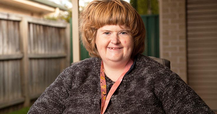 Kate who has Prader Willi syndrome, in her backyard