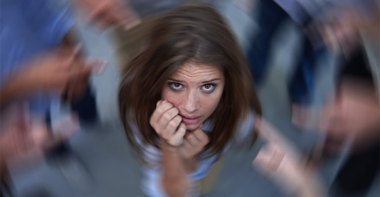 Women having a panic attack while the world spins around her