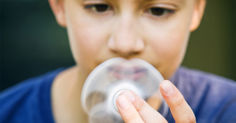 Boy stimming by using a fidget spinner