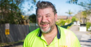 Peter who has bipolar, standing outside while working at House with No Steps