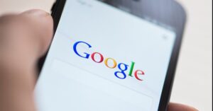 Someone's hand holding a phone with Google open