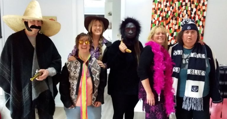 Lisa and her customers at a fancy dress party