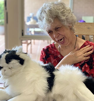 Cathy with her cat, tears on her face