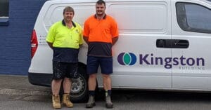 Sam and his manager standing in front of a white truck