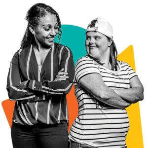 NDIS support worker and participant standing back to back, out in the community