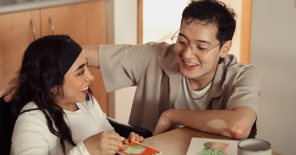 Aruma support worker and participant sharing a meal together at home.