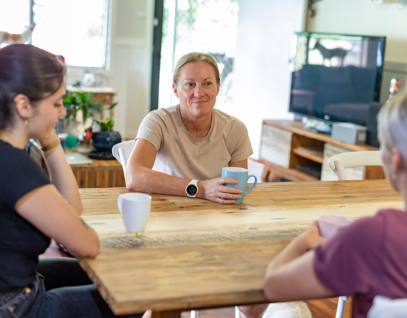 Three women chatting over a cup of tea in their Supported Independent Living home