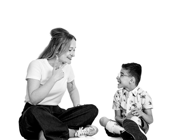 A child and therapist sharing a relaxed, happy moment during therapy services