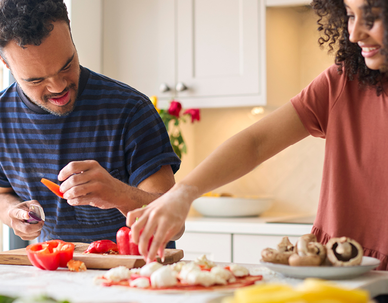 A participant and support worker preparing a meal together in the kitchen during medium term accommodation