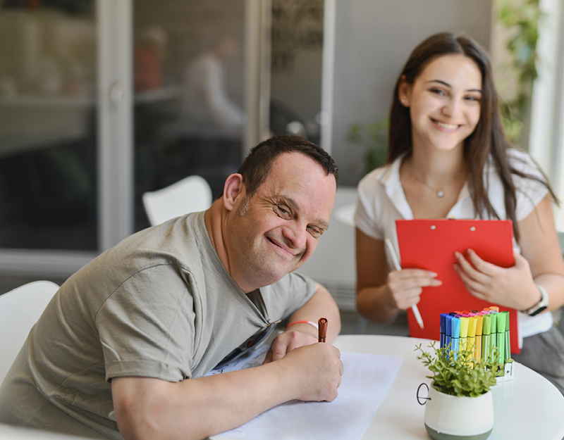 A participant and support worker reviewing information together about your rights