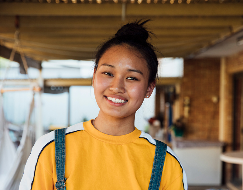 A teenage girl smiling confidently at home, representing occupational therapy for young people
