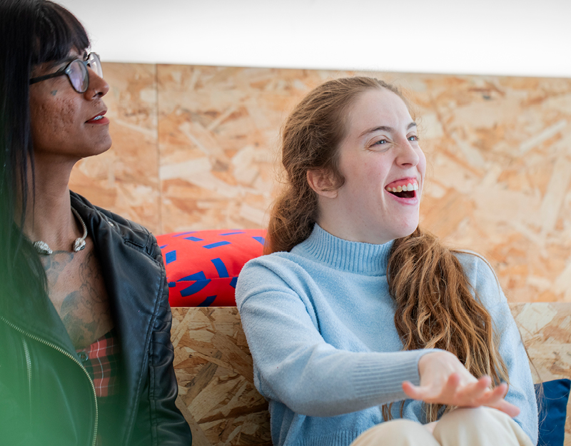 A teenager gesturing while talking with a support person during speech pathology services for young people