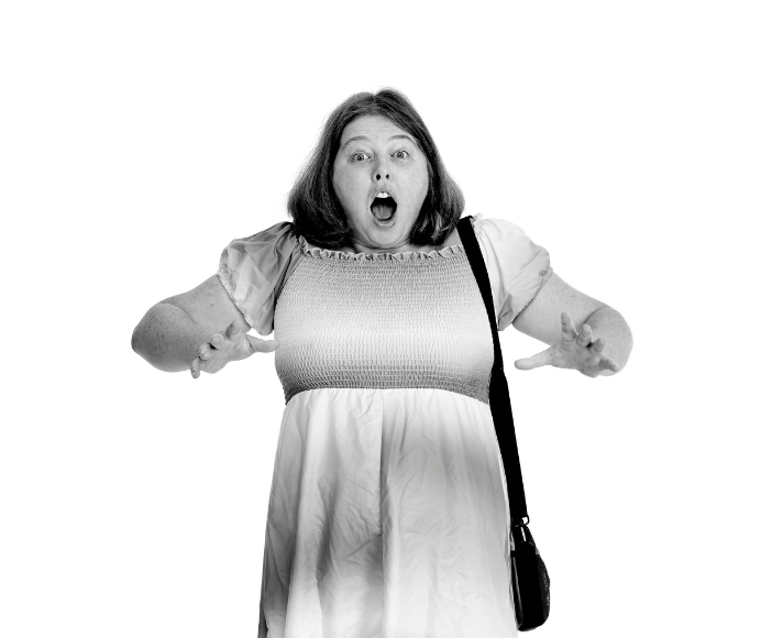 Olivia striking a fun, expressive pose with her arms out