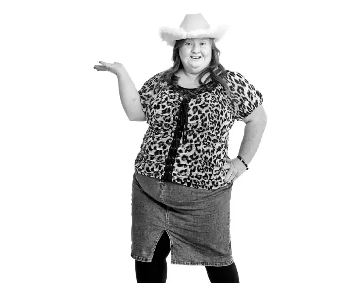 Allison posing stylishly in a cowboy hat with her hand on her hip