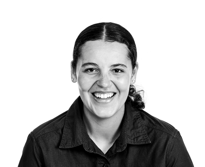 Rosie smiling warmly in her work shirt"