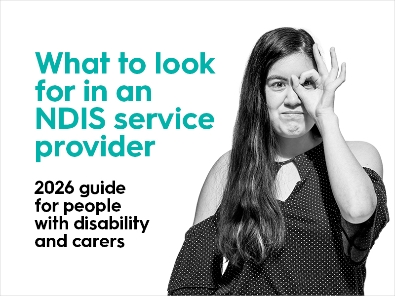 An image with the title text that reads "what to look for in an NDIS service provider" the image is of a woman holding her hand up to her eye, she's looking through her fingers