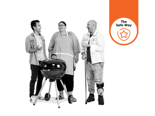 Three people stand around a BBQ chatting and laughing. There is a 'The Safe Way' icon on the right hand side of the image.