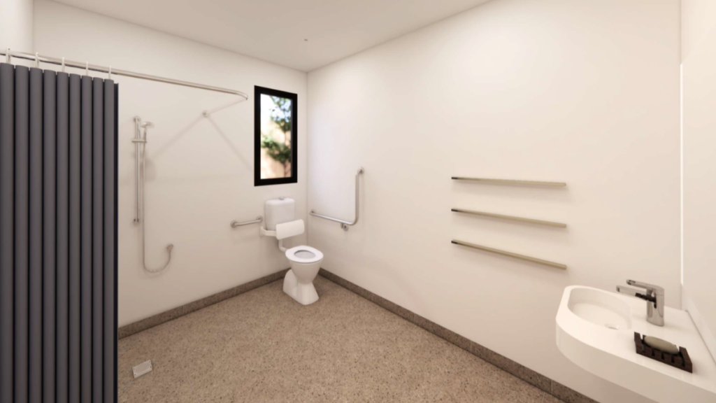Render of an accessible ensuite bathroom inside a Croydon SDA home, showing a roll-in shower with grab rails, toilet with grab rails, wall-mounted basin and non-slip flooring.