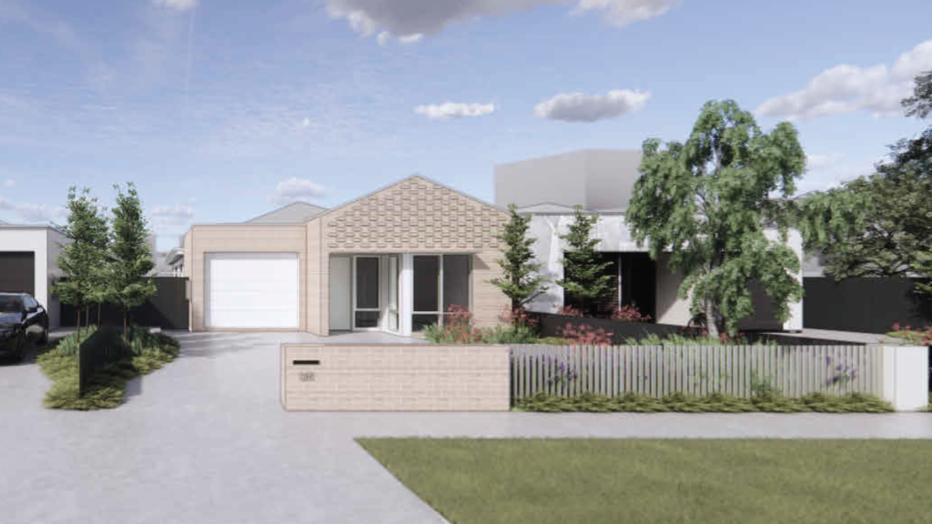 street view of a Thomastown SDA home showing the brick facade with decorative gable detail, integrated garage, front fence with letterbox, mature trees and landscaped gardens throughout the development.