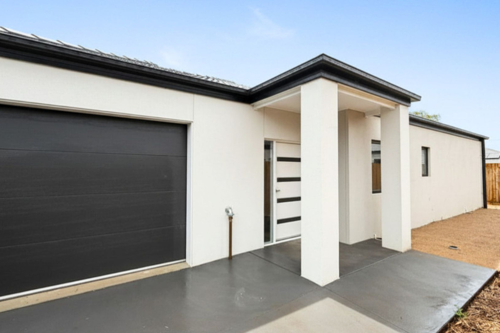 2. Front exterior of the Sale SDA home, showing a single-storey accessible build with a covered front entry, single garage and concrete driveway.