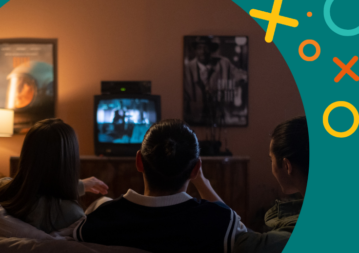 image showing people sitting down watching a movie on television