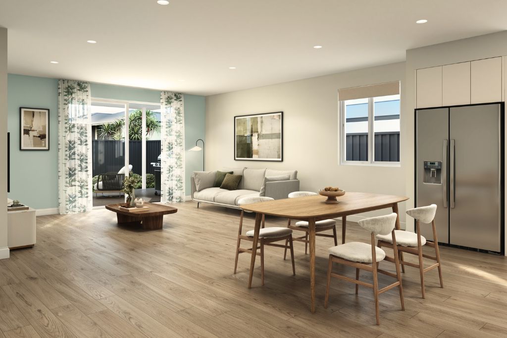 Living and dining area inside the Wangaratta SDA home, showing timber-look flooring, sliding doors opening to the outdoor entertaining area and a dining setting alongside the lounge.