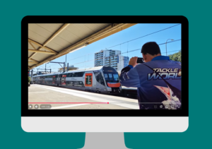 An image of Paul taking a video of a train pulling into a station.