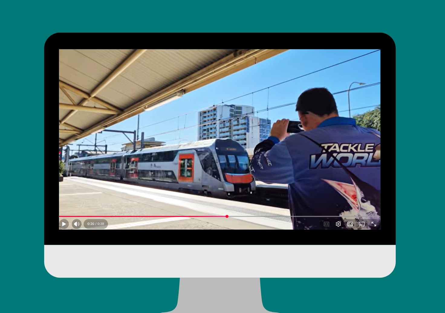 An image of Paul taking a video of a train pulling into a station.
