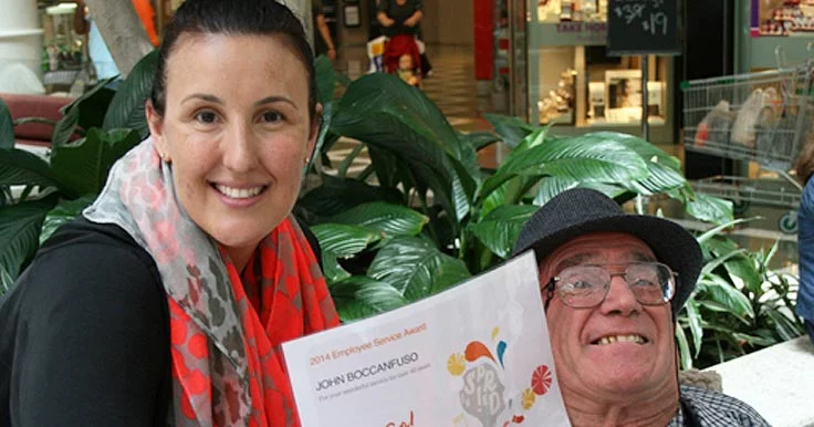 John Boccanfuso receiving a certificate from an Aruma staff member