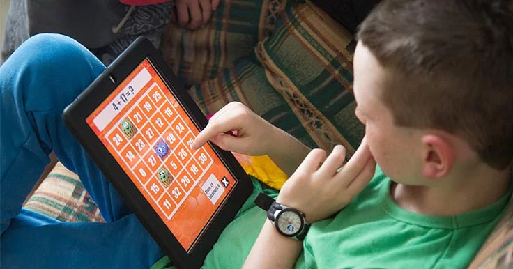 Boy with a disability using an iPad and an assistive technology app