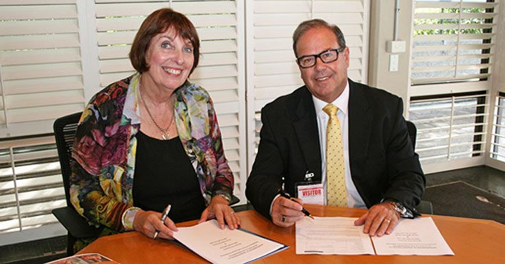 Head of Strategy, People & Practice, Lyn Ainsworth signing the partnership agreement with Blooms The Chemist CEO, Phil Smith.