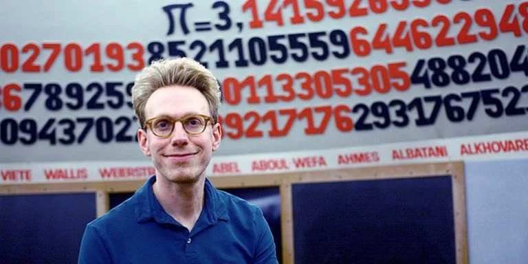 Daniel Tammet standing in front of the number pi