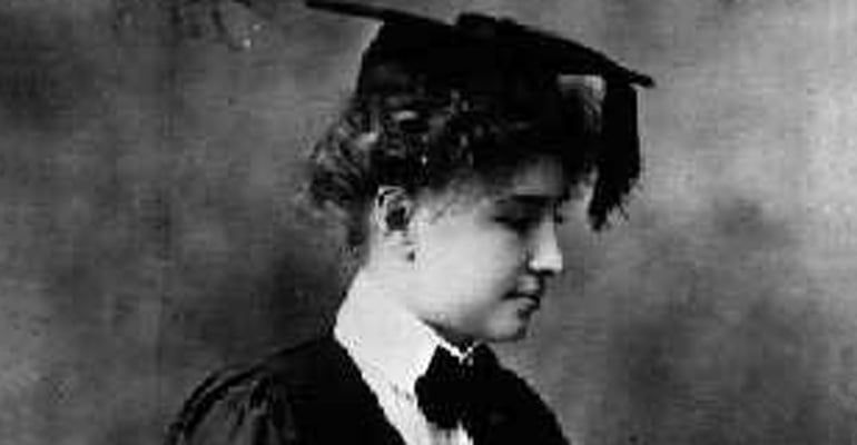 Helen Keller wearing a graduation cap and robe