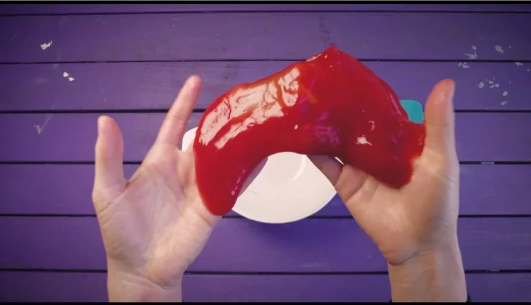 Close of of a person's hands holding the slime sensory activity