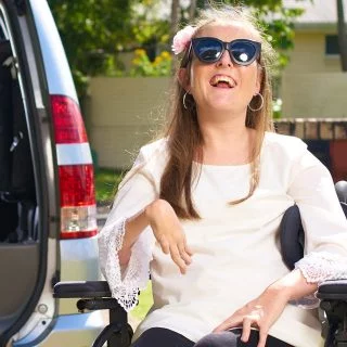 An Aruma customer in front of an accessible vehicle