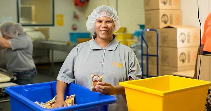 A Supported Employee from Aussie Biscuits working in the factory