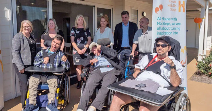 A group of Aruma customers and staff at the opening of Towns Avenue Supported Independent Living (SIL) accommodation