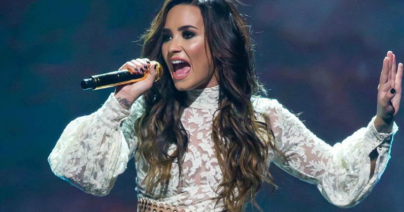 Demi Lovato singing into a microphone