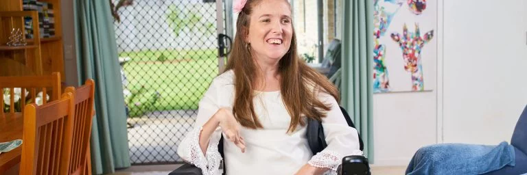 Woman who uses a wheelchair in a house which includes home modifications