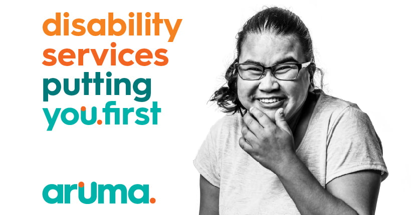 An Aruma customer with a disability with the words 'disability services putting you first'