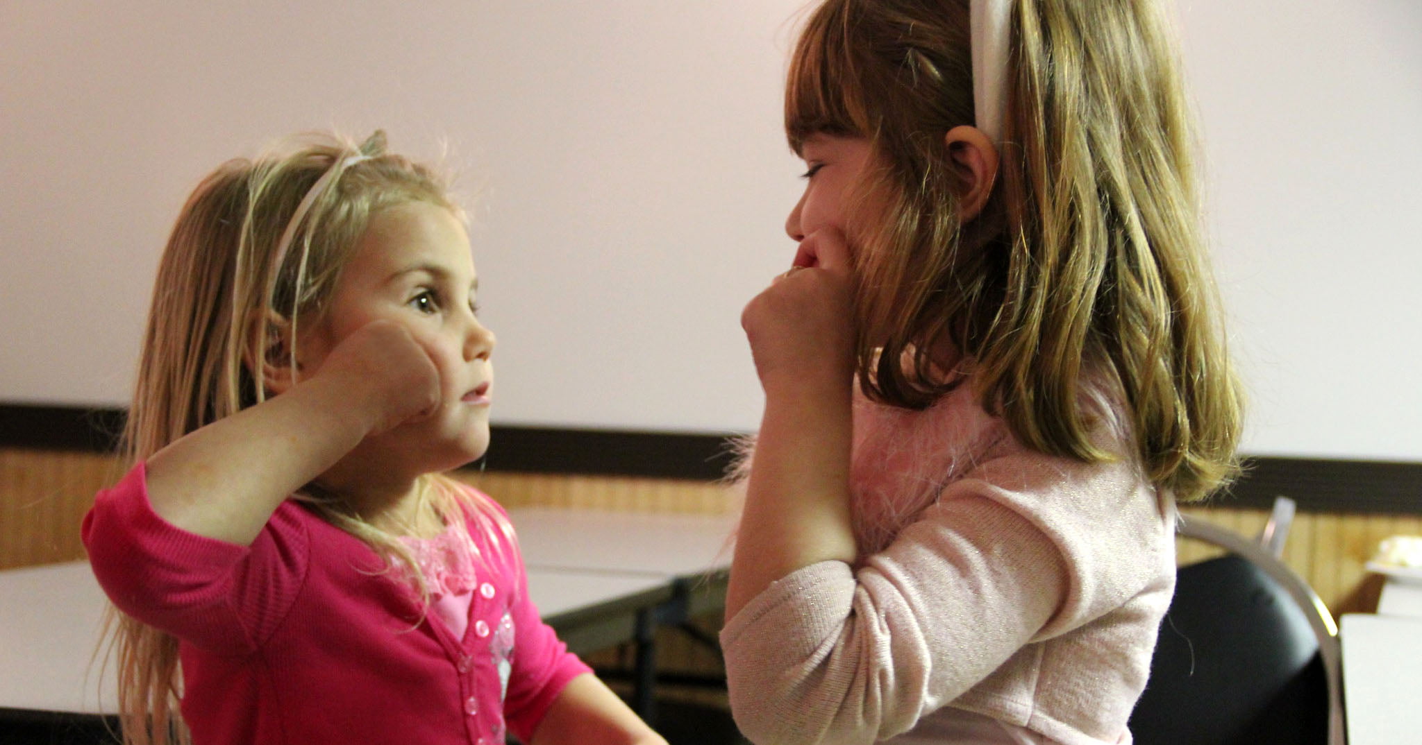 Two sisters signing at each other