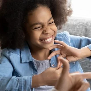Young girl with a disability using sign language