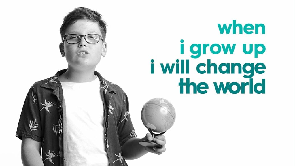 Child with a disability holding a small globe with the words 'when I grow up I will change the world'