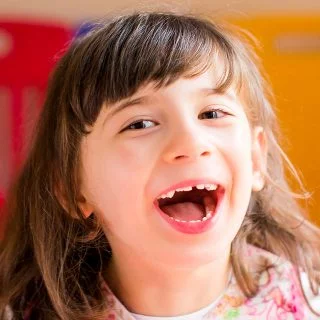 Girl smiling in front of a colourful background