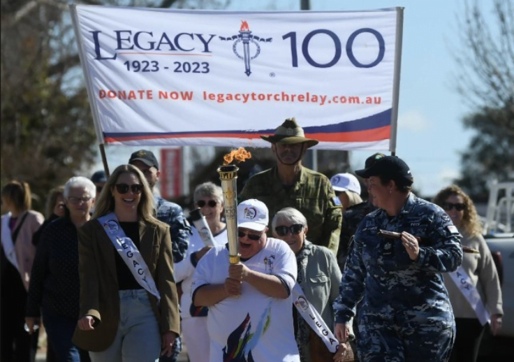 Aruma customer Paul Findlay carrying the torch at the 2023 legacy torch relay in Forbes.