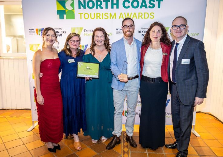 Aruma staff at the North Coast Tourism Awards Ceremony night holding the certificate and the trophy that they recevied.