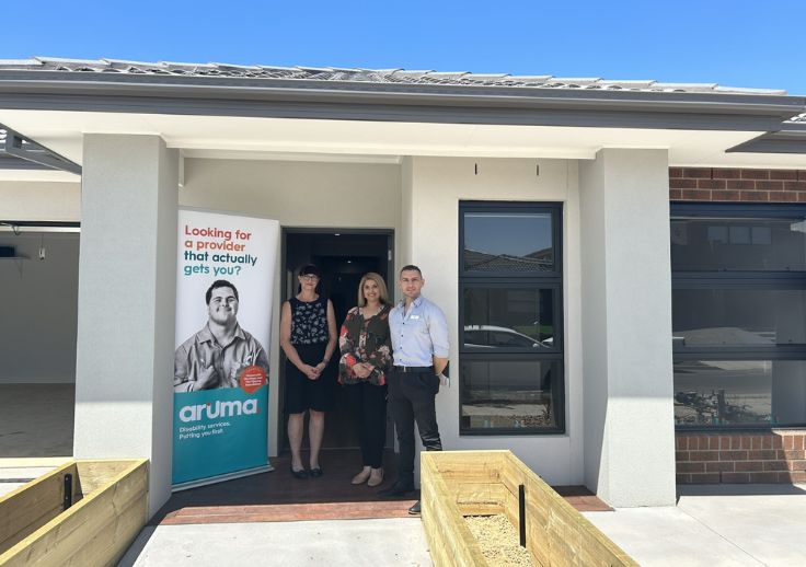 three aruma representatives outside the new build SDA home in tarneit on the opening day.