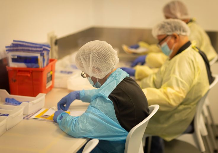 Aruma Supported Employees working at the forensics and packaging facility in burleigh.